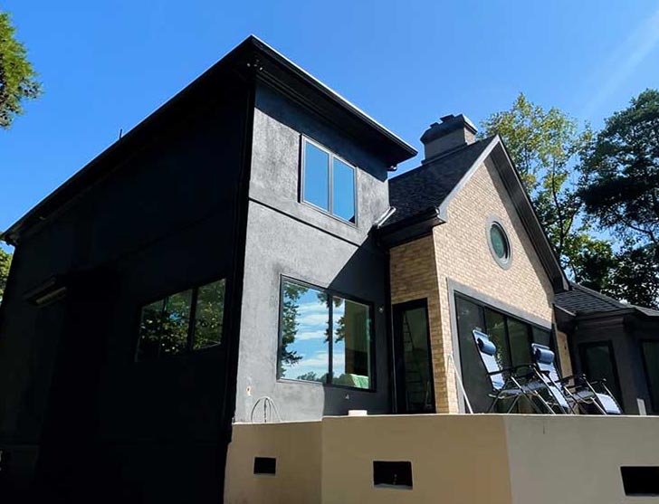 Photograph of remodeled house, paint change and repairs on the facade